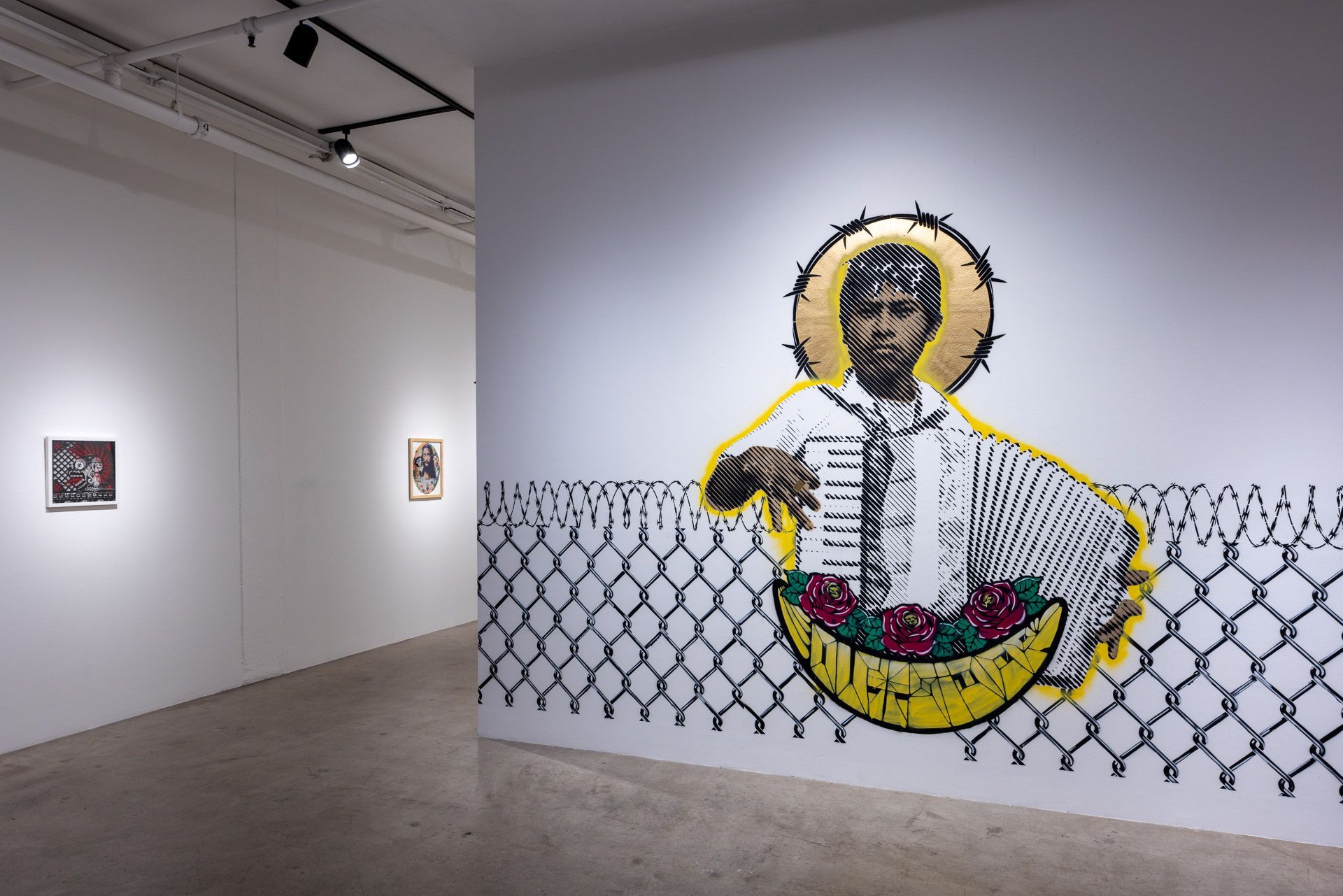 There is a painting of a man playing an accordion on the wall.