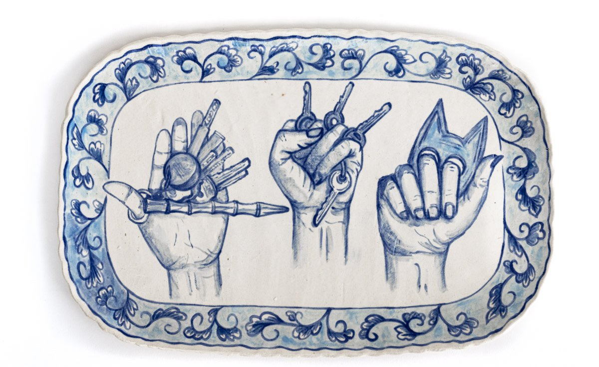 A blue and white plate with three hands on it
