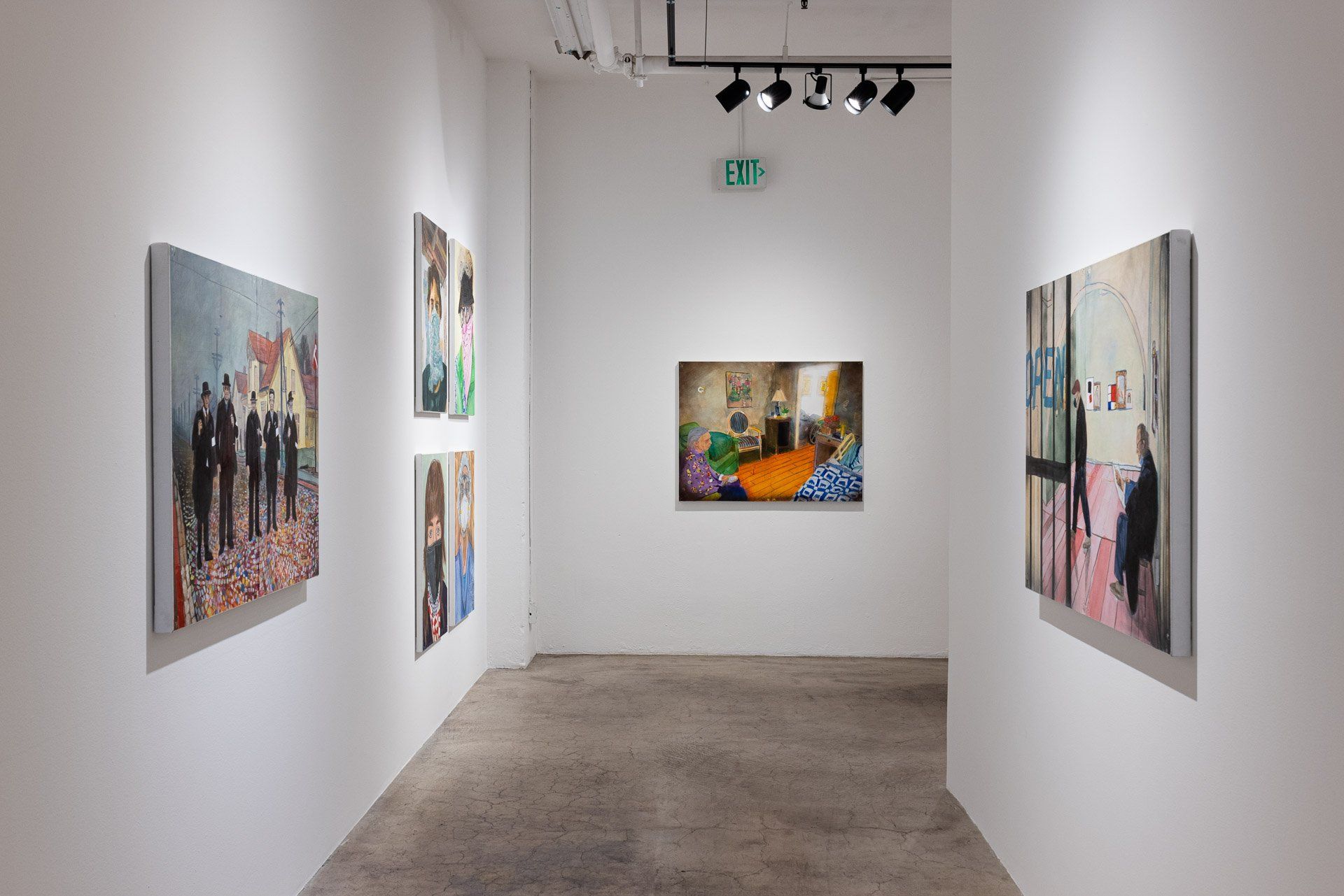 A long hallway with paintings on the wall in Track 16 Gallery.