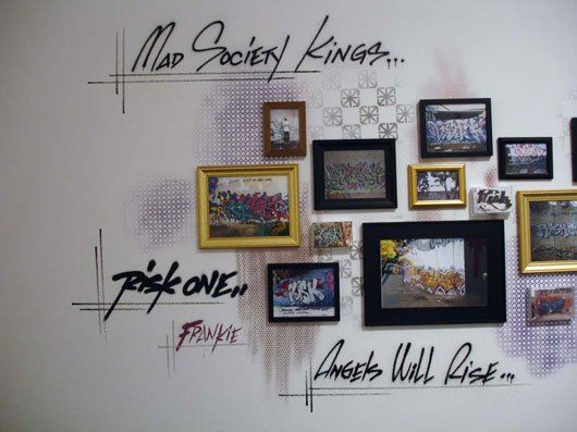 A wall with pictures and the words mad society kings written on it