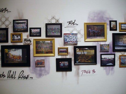A wall with a lot of pictures on it and the words wall rise on it