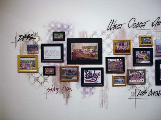 A wall with a bunch of framed pictures on it