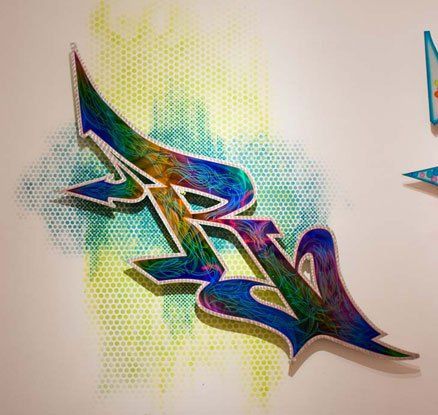 A colorful graffiti drawing of the letter r on a white wall