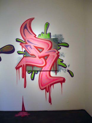 Graffiti on a wall that has the letter b on it