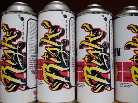 Several cans of brake paint are lined up in a row