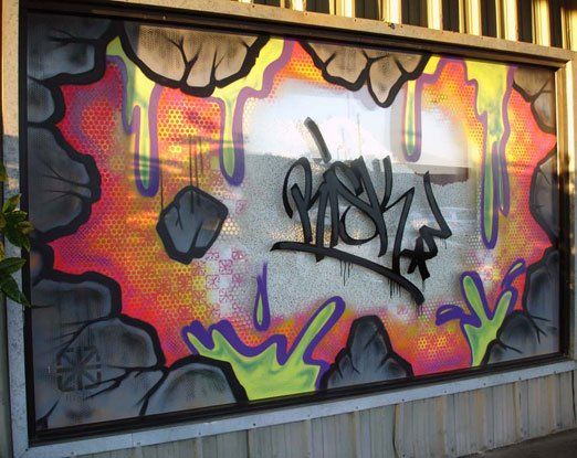Graffiti on a window that says ' shay ' on it