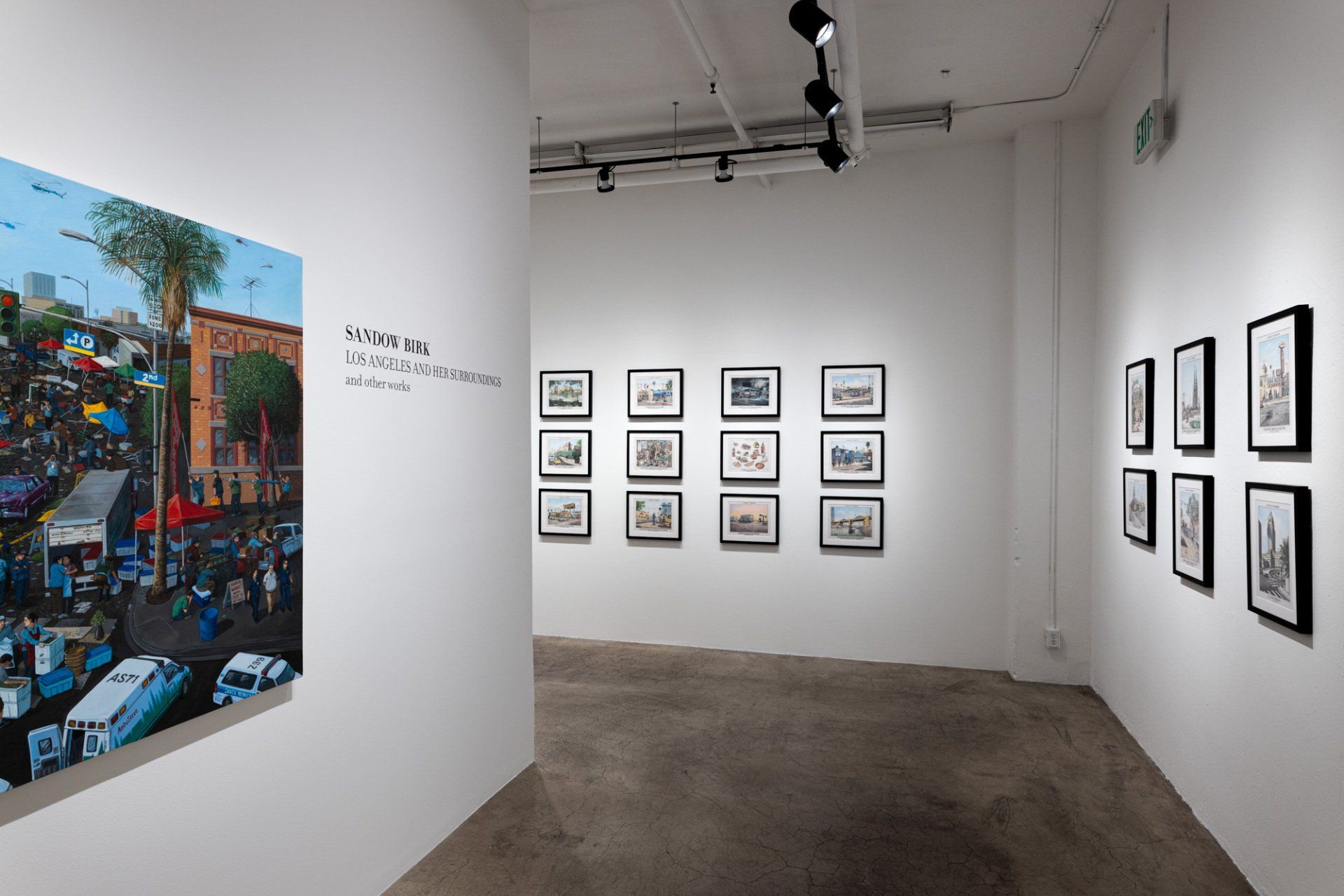A room with a lot of pictures on the wall and a painting on the wall.