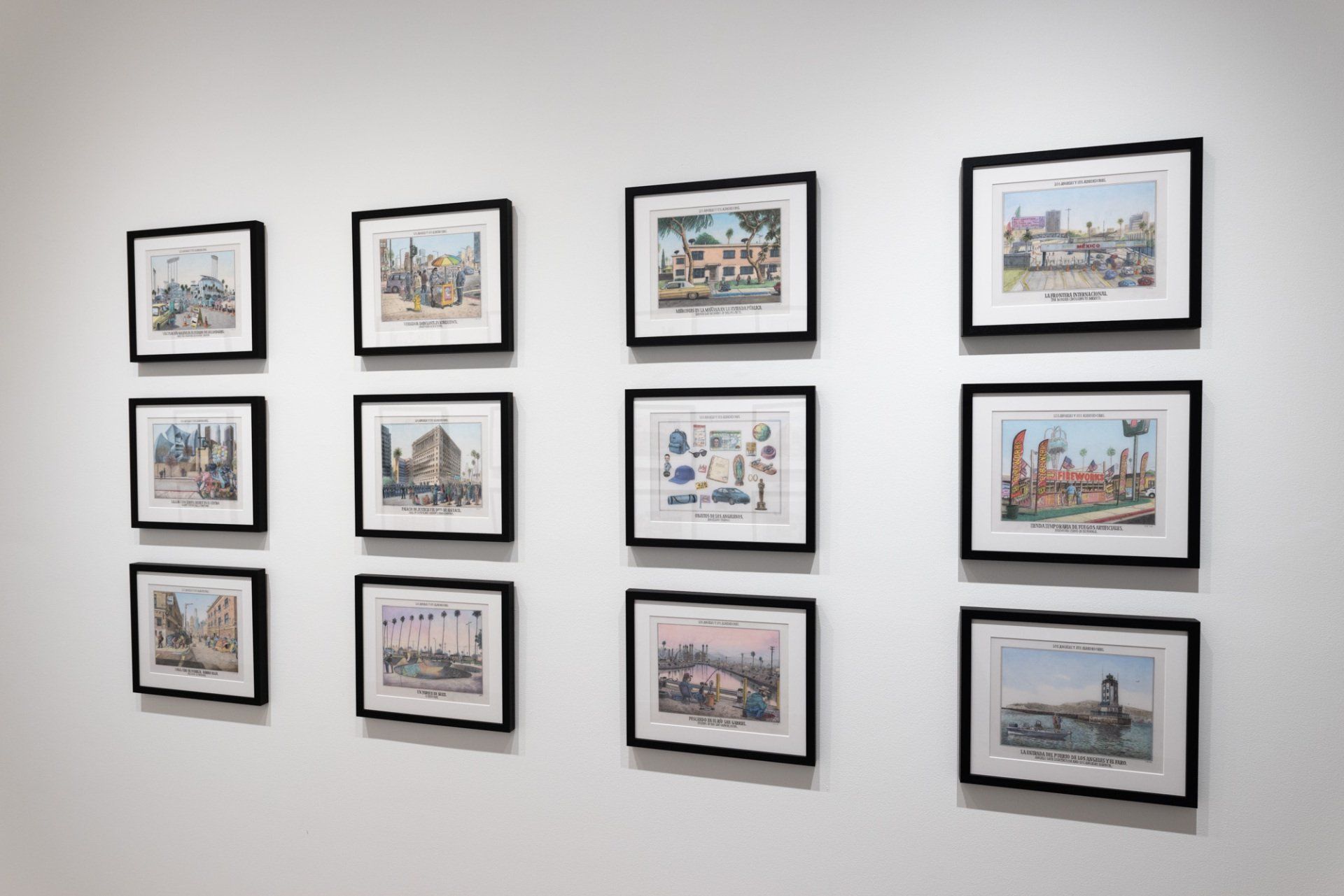 A wall with a bunch of framed pictures on it.