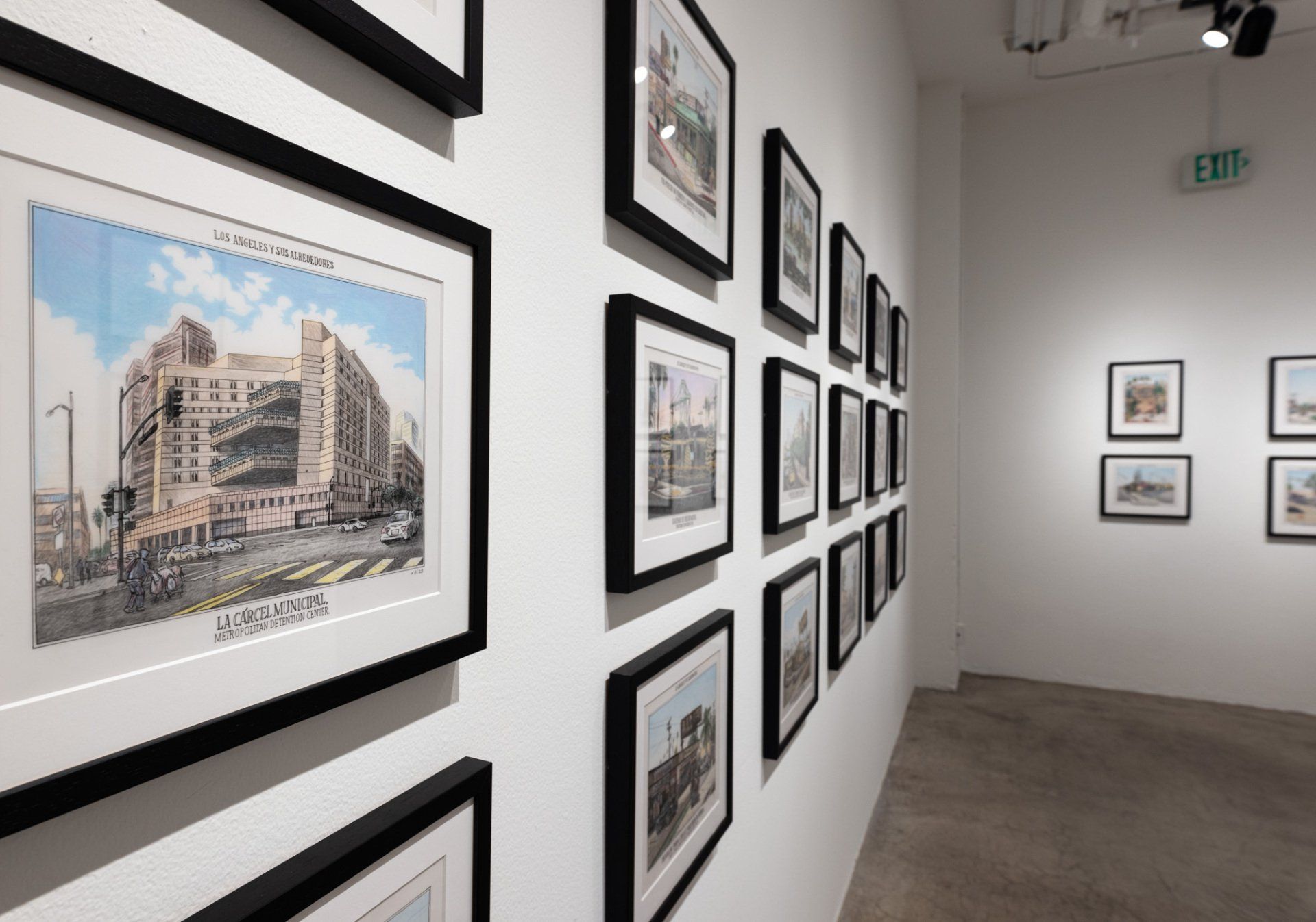 A room with a lot of framed pictures on the wall.