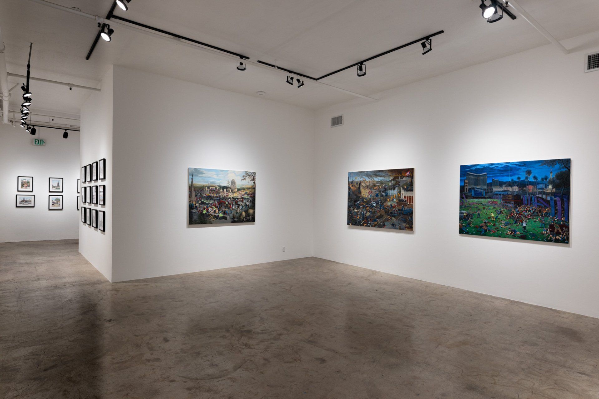 There are a lot of paintings on the wall in this room.