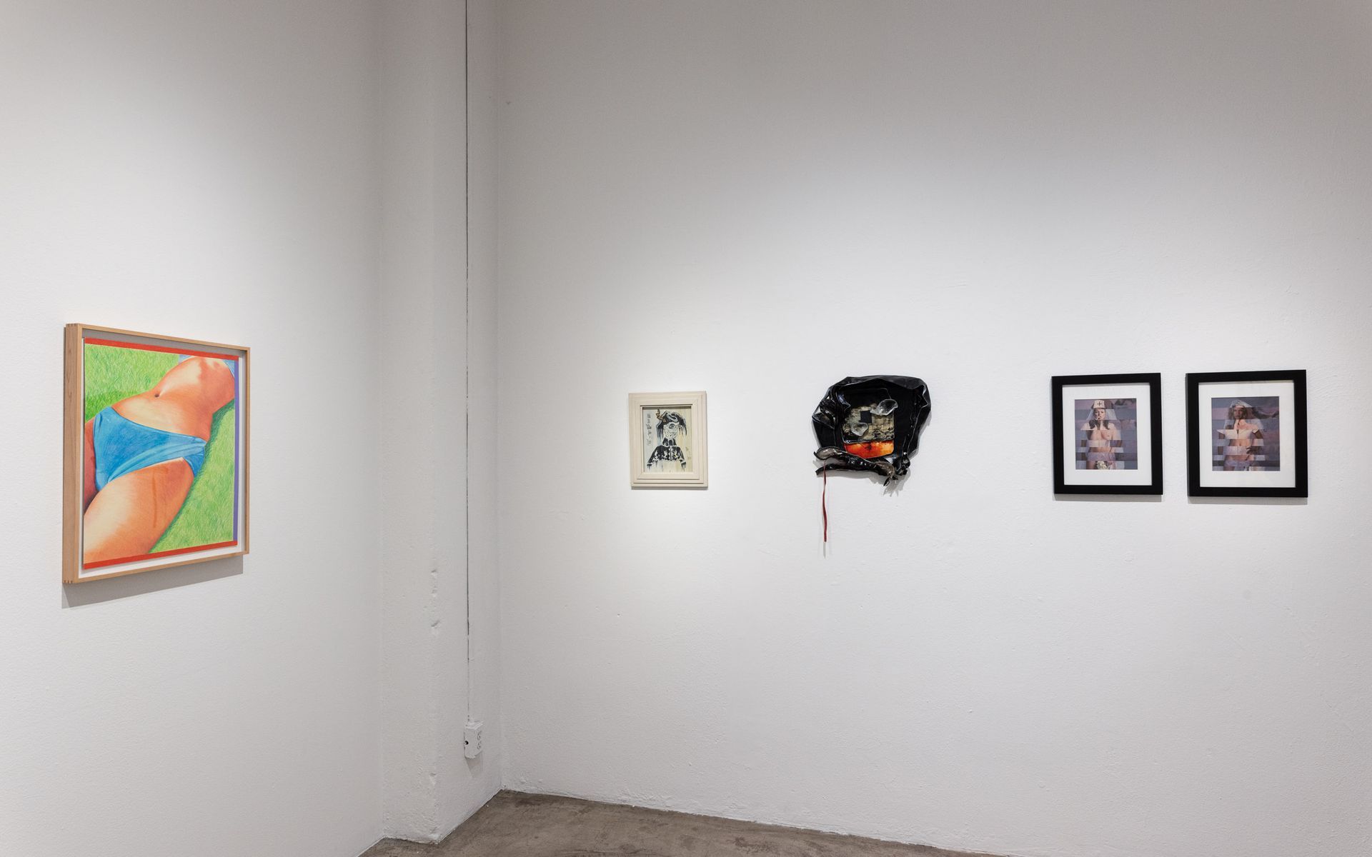White gallery wall with four framed artworks, including a colorful abstract piece on the left. Summer Bullet Sings, an exhibition of thirty-five artists organized by gallery director Sean Meredith and curator Diana Sardaryan