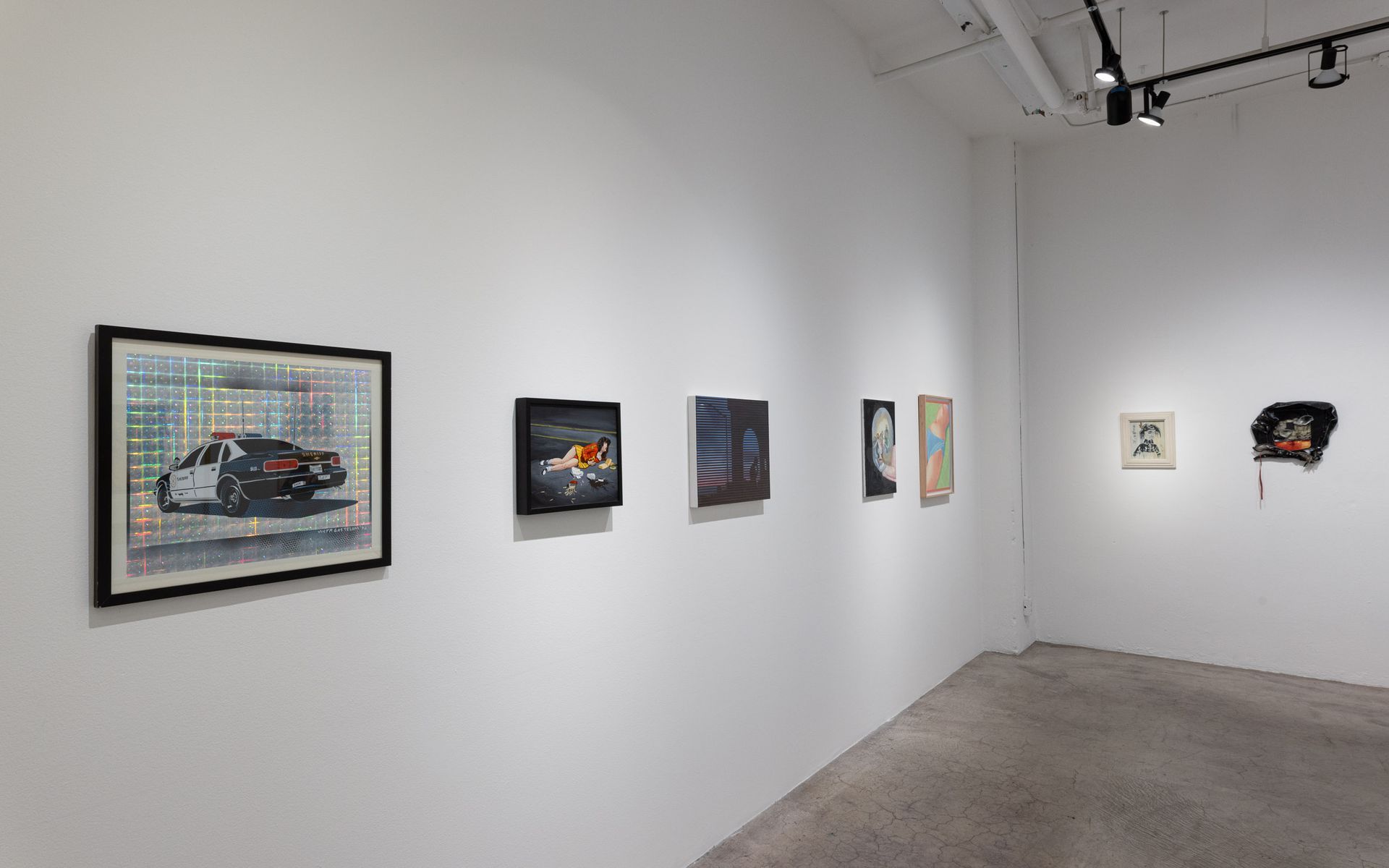 Small gallery wall with framed artworks displayed in a bright white exhibition room. Summer Bullet Sings, an exhibition of thirty-five artists organized by gallery director Sean Meredith and curator Diana Sardaryan
