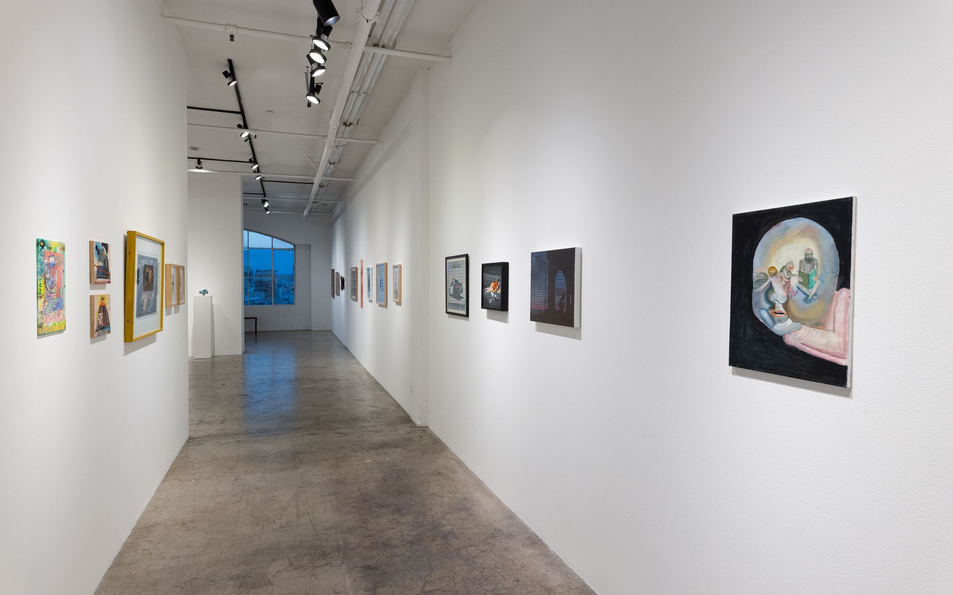 White gallery hallway with framed artworks on both walls and a polished concrete floor. Summer Bullet Sings, an exhibition of thirty-five artists organized by gallery director Sean Meredith and curator Diana Sardaryan
