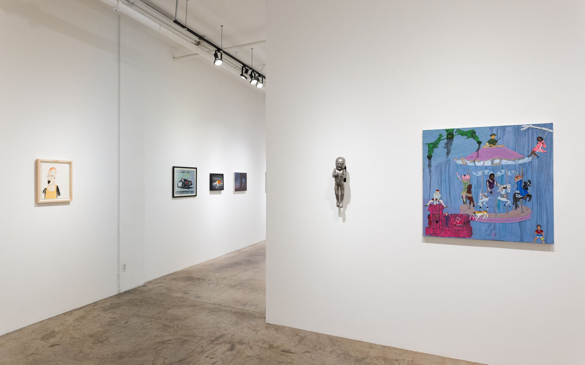 Art gallery hallway with small colorful paintings on white walls and a blue artwork in the foreground. Summer Bullet Sings, an exhibition of thirty-five artists organized by gallery director Sean Meredith and curator Diana Sardaryan.