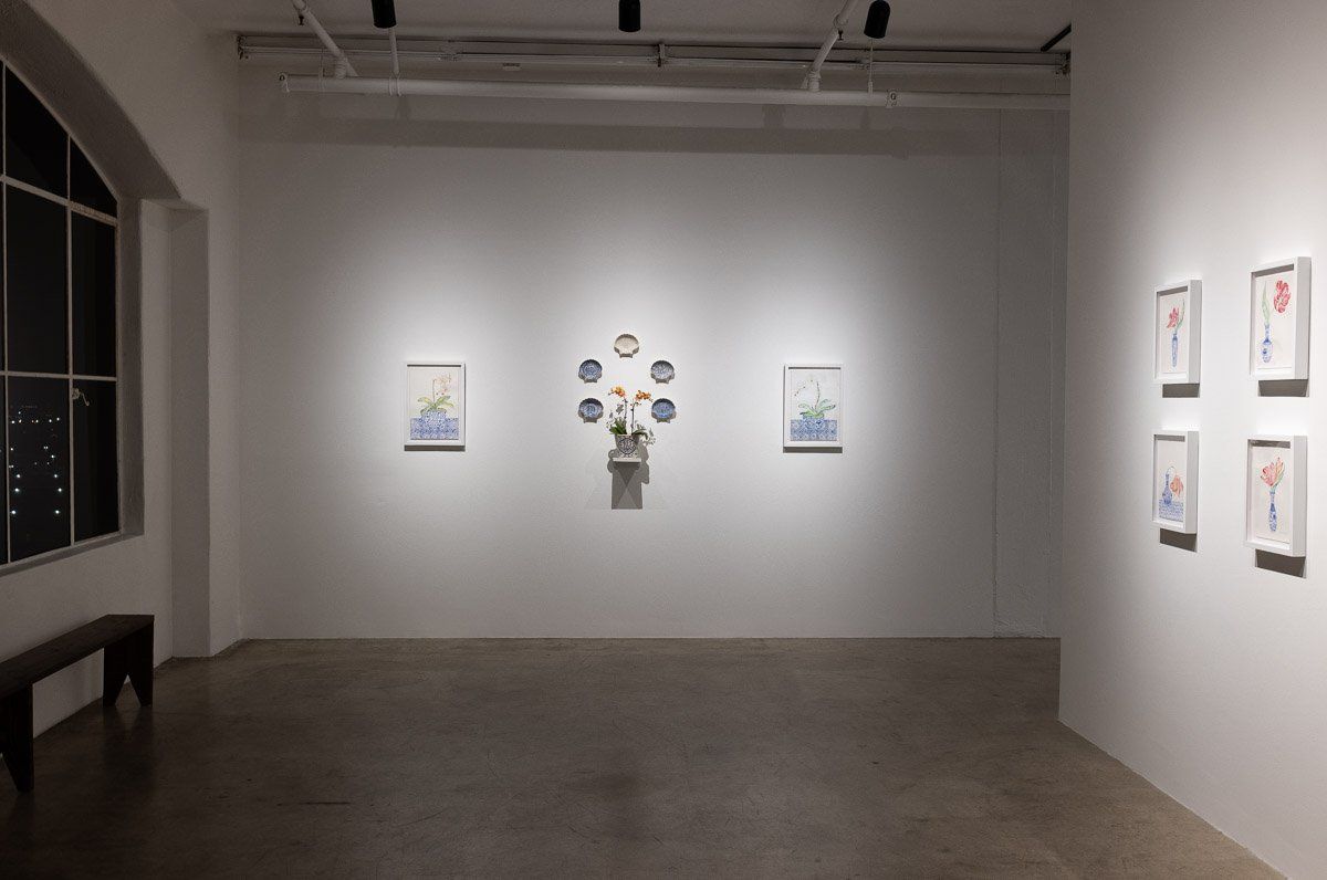 There are a lot of paintings on the wall in this room.