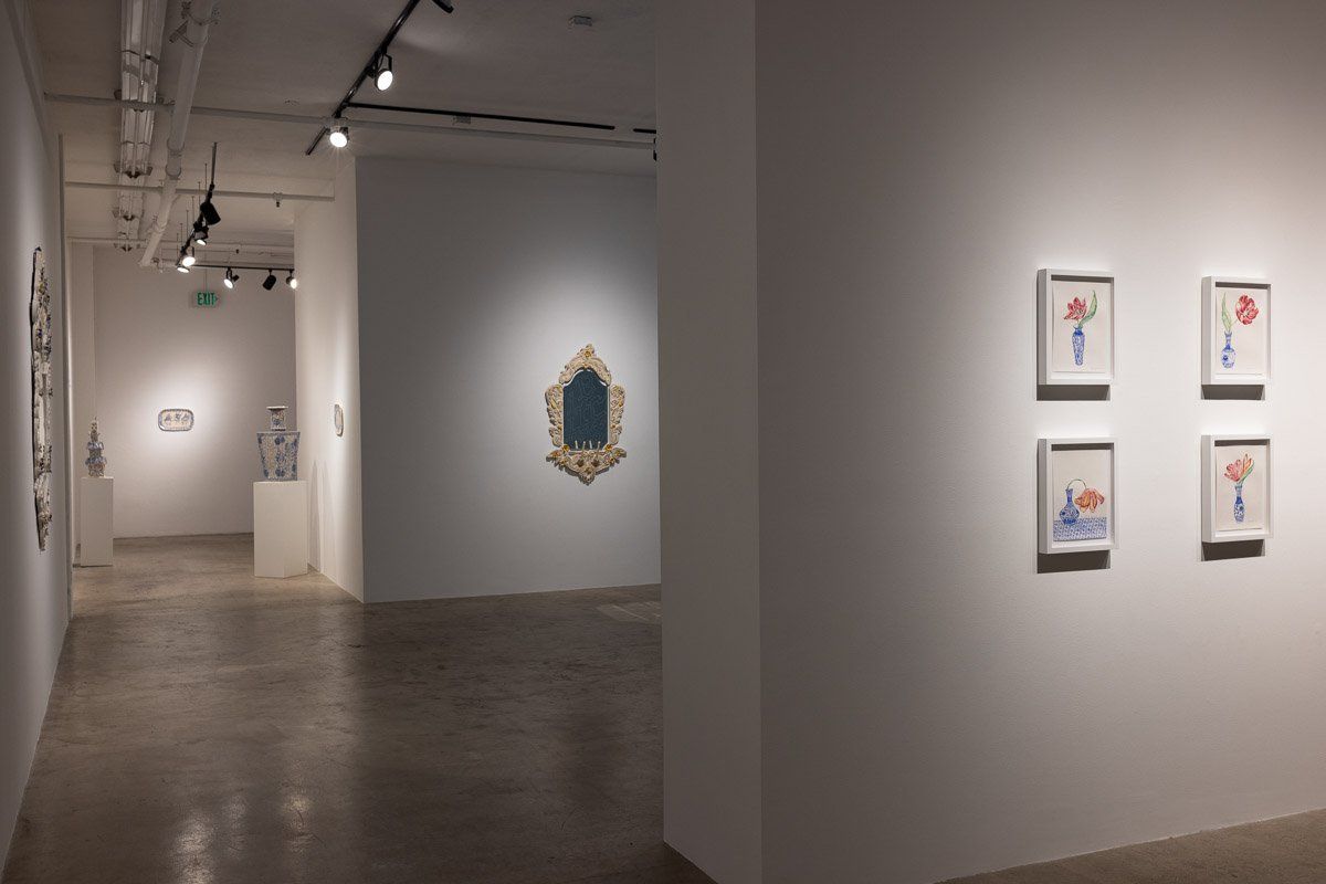 There are a lot of paintings on the wall in this room.