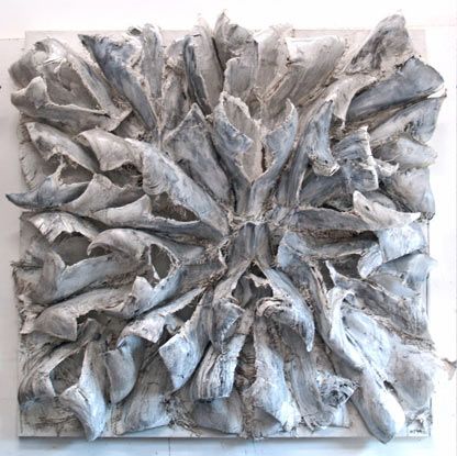A white sculpture with a circular pattern on it