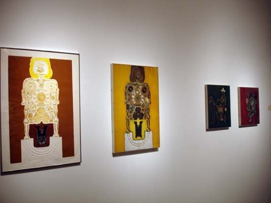 A row of paintings are hanging on a white wall