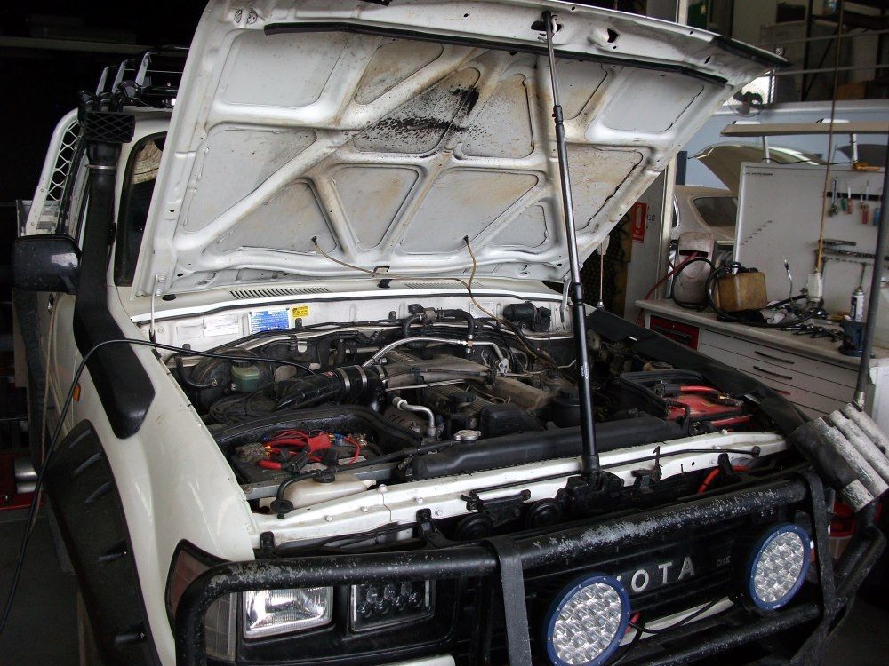 A White Toyota Truck With The Hood Open In A Garage — Gympie Diesel & Dyno Centre in Glanmire, QLD