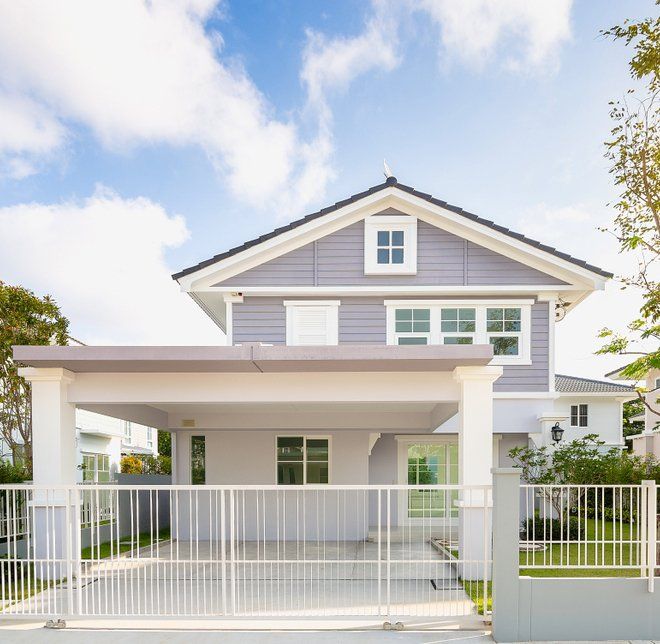 A house with a Carport and a Fence in front of it — New Homes in Wamberal, NSW