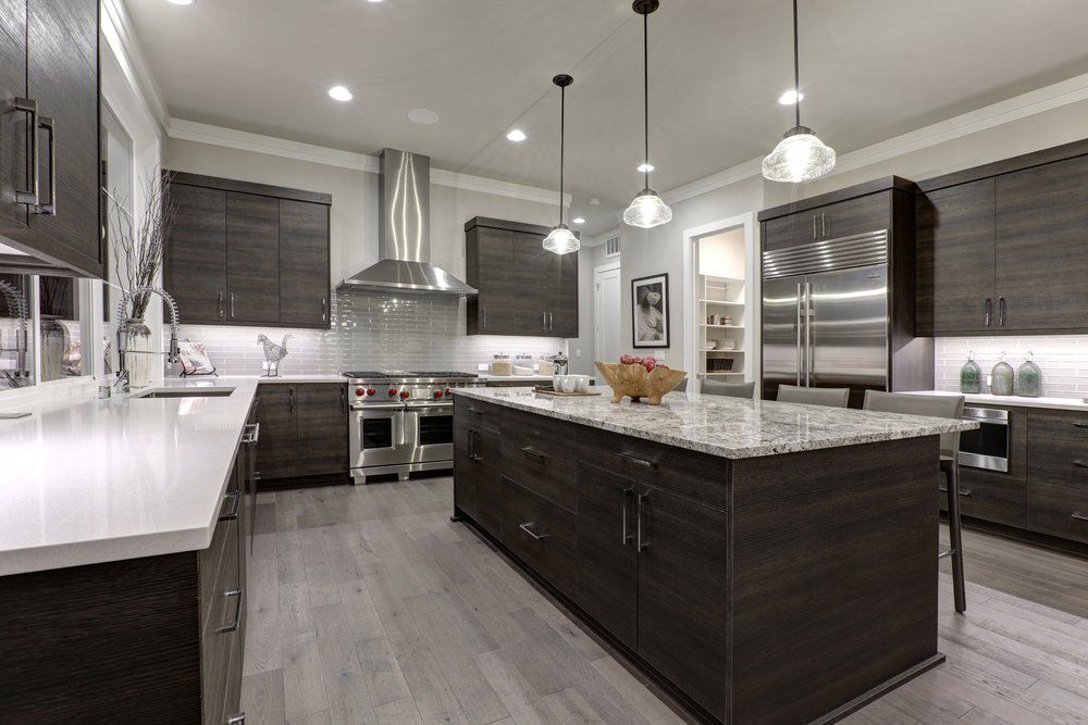 Modern gray kitchen features dark gray flat front cabinets — New Homes in Wamberal, NSW