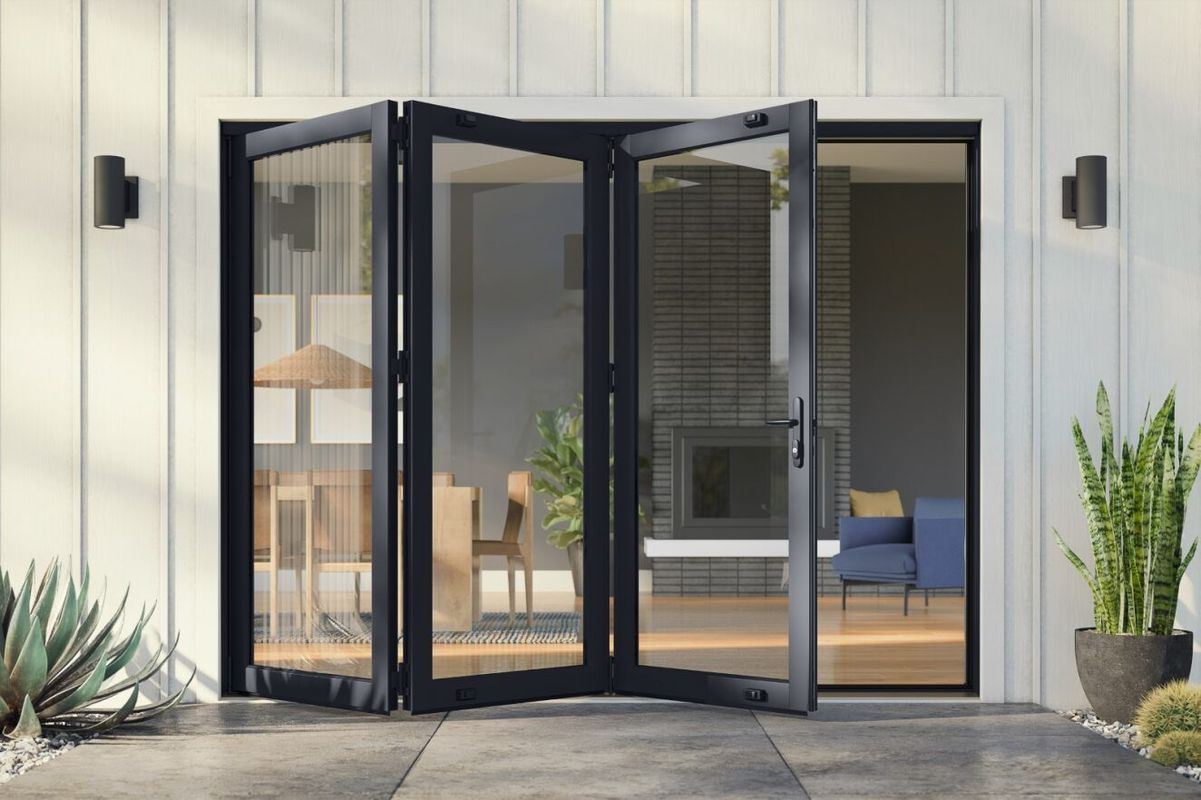 Black-framed glass folding doors open to a modern patio and bright interior.