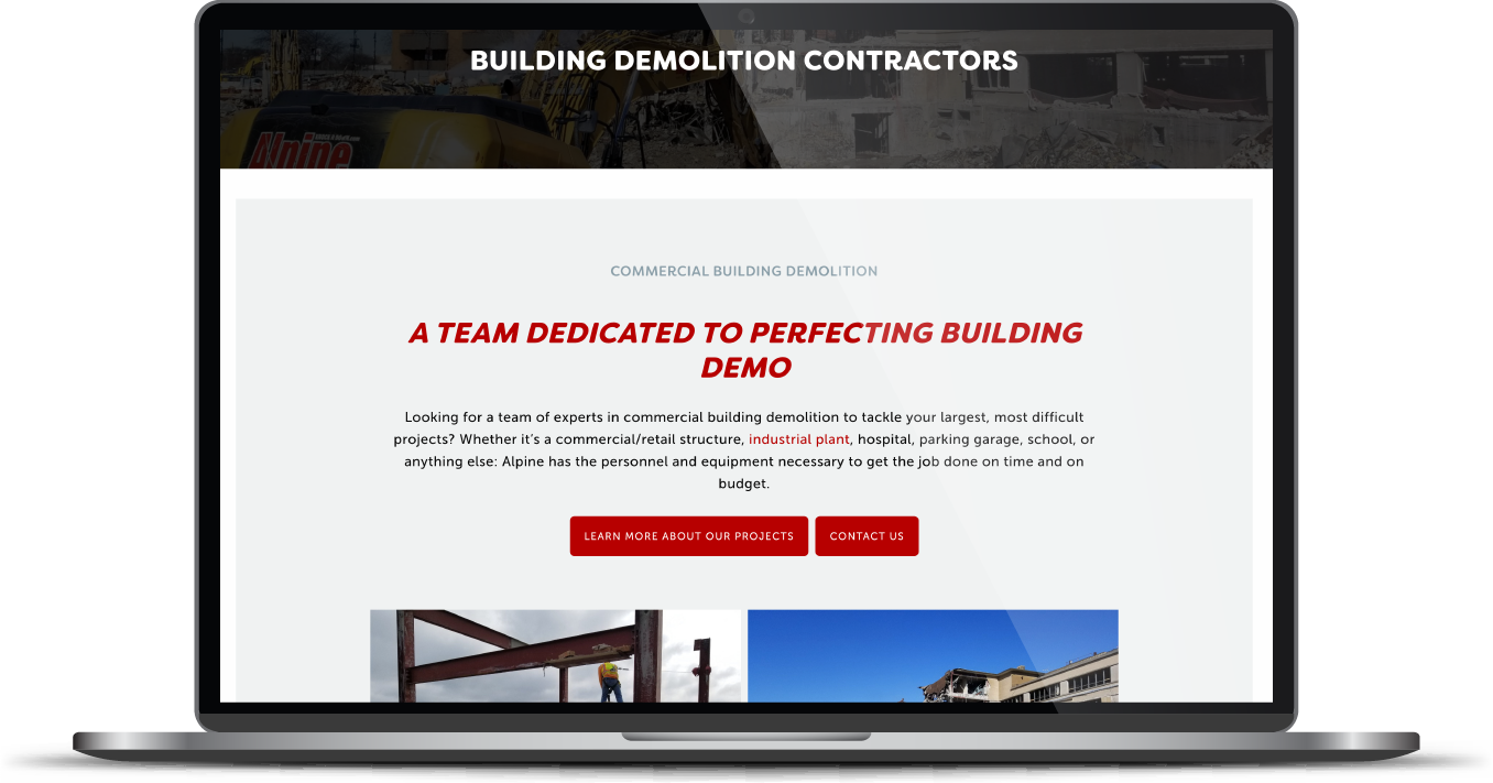Laptop displaying a demolition contractor website with a red-and-white homepage banner and building image