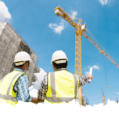 Two construction workers in hard hats and safety vests point at a crane on a building site.