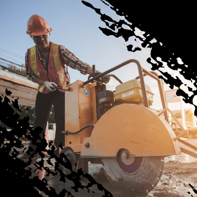Construction worker operating a yellow road roller at a worksite