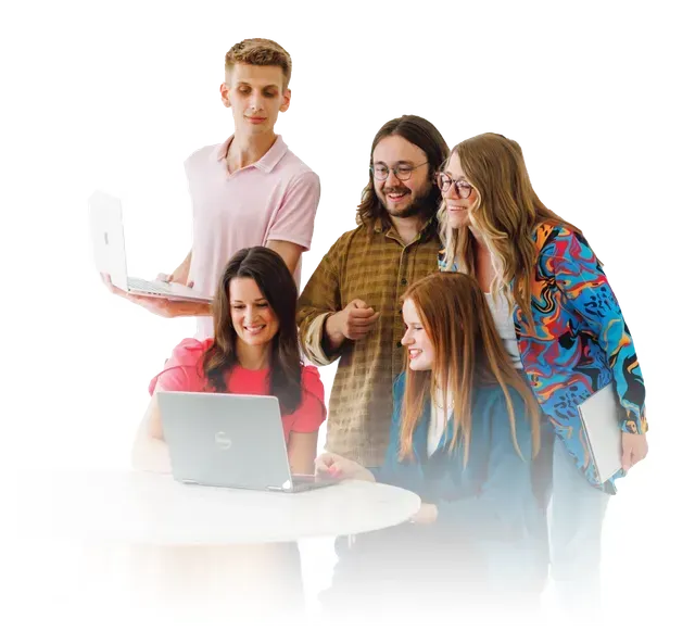 Five coworkers gathered around a laptop in a bright white office, smiling and collaborating.
