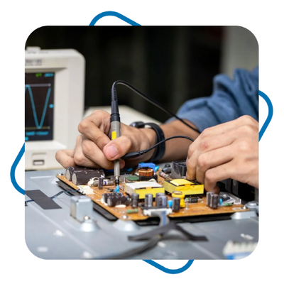 Technician soldering circuit board with oscilloscope in electronics lab