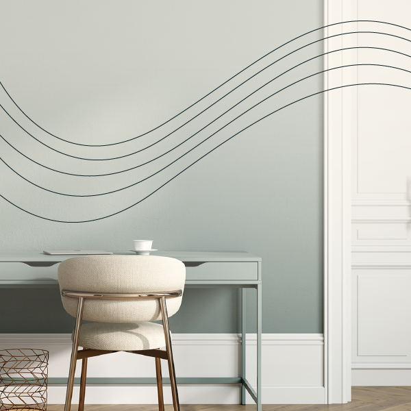 Minimalist living room with wavy wall art, pale blue desk, and beige chair on a light wood floor.