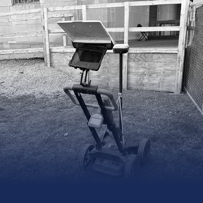 Smartphone mounted on a stand in a barn or workshop, with a blue gradient at the bottom.
