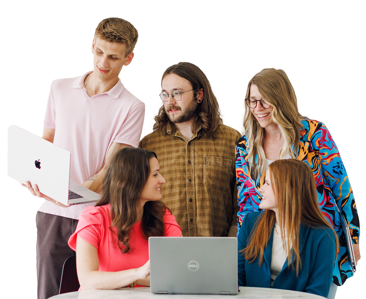 Five coworkers gathered around two laptops, discussing a project in a bright studio.