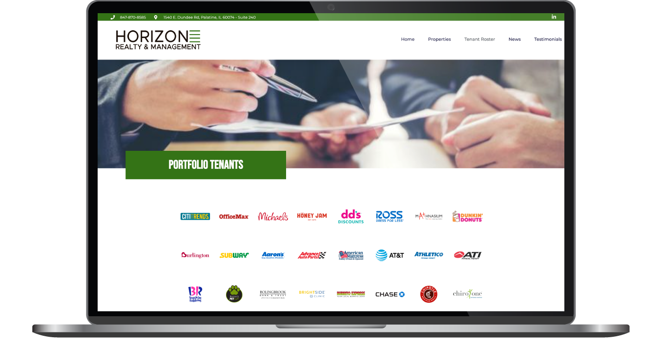 Laptop displaying a business website with a handshake banner and company logos below