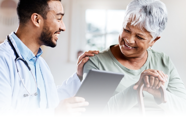 Doctor showing a tablet to a smiling patient in a bright clinic