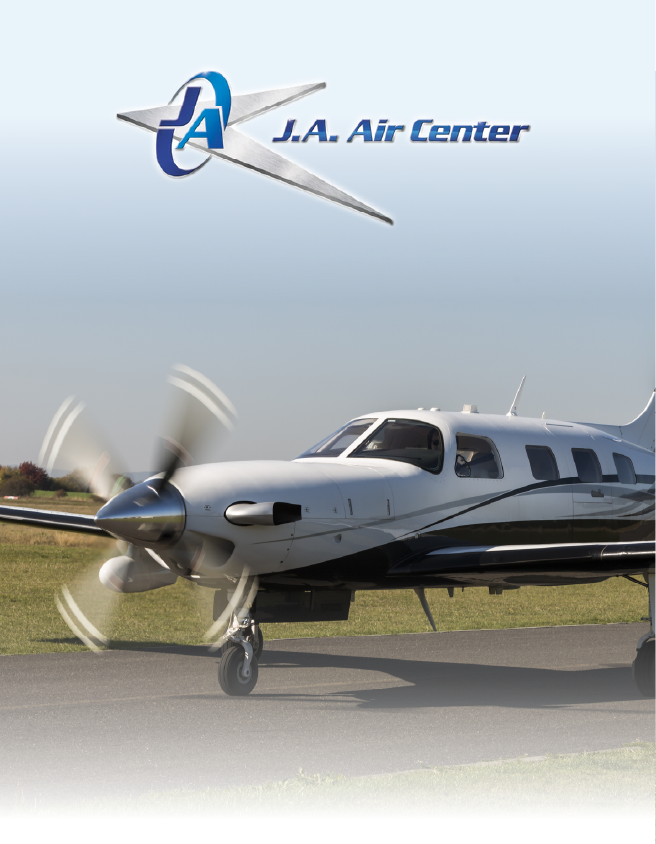 Single-engine airplane on a runway with spinning propeller and J.A. Air Center logo above
