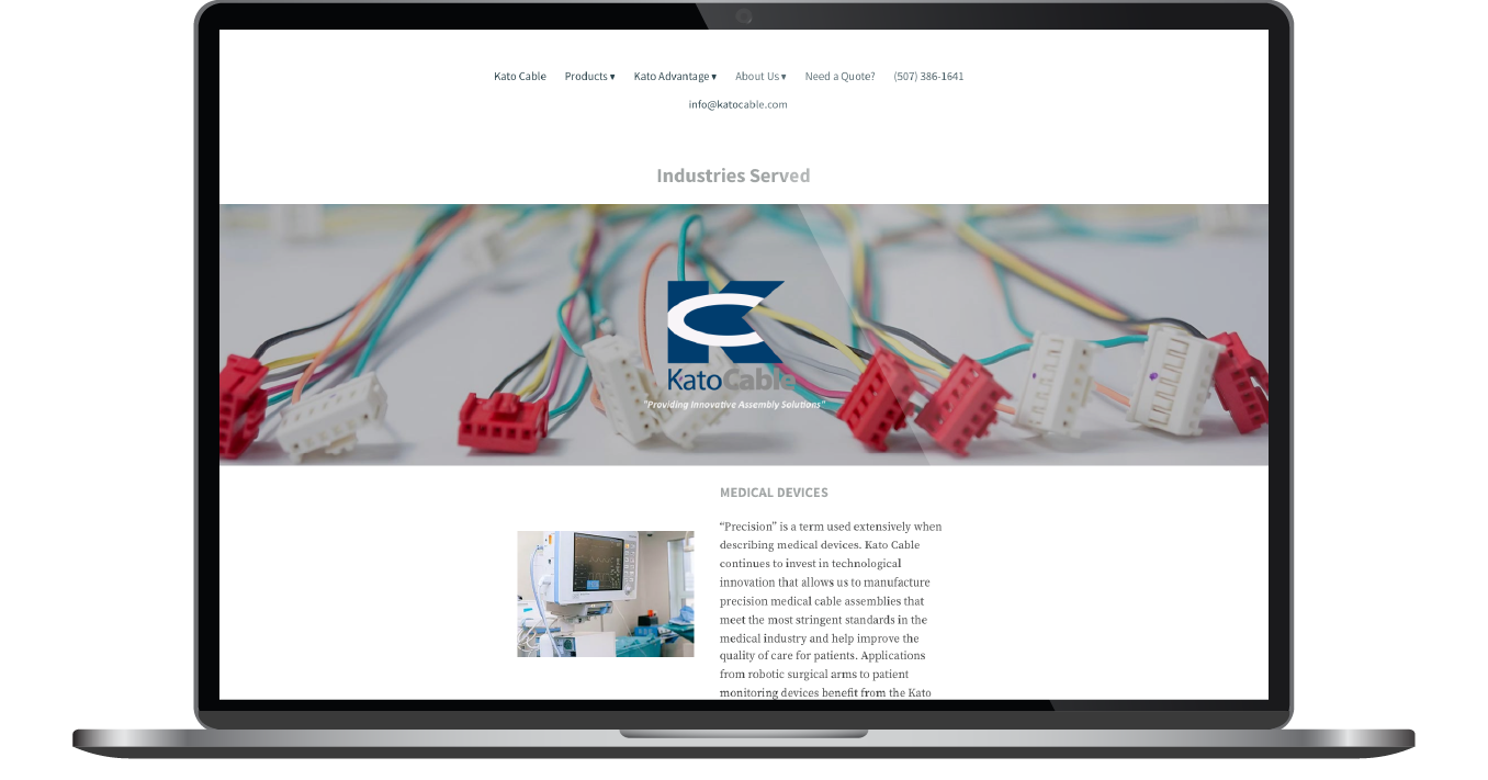 Laptop displaying a website with a large banner image of colorful wires and a small text section below.