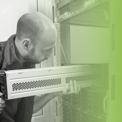 Technician installing a rack-mounted server in a data center cabinet