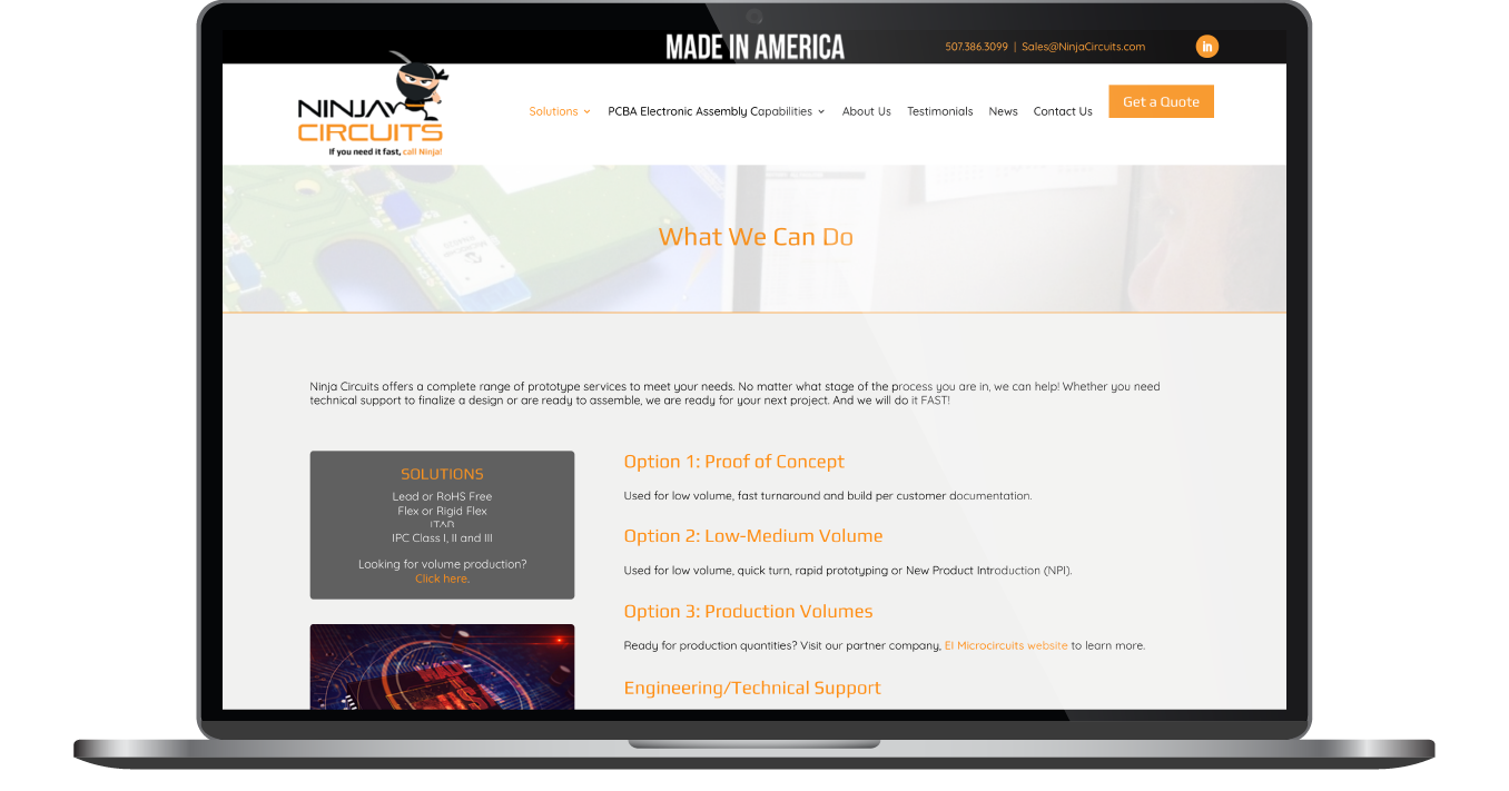 Laptop displaying a website with a dark header, orange accents, and a blog-style layout