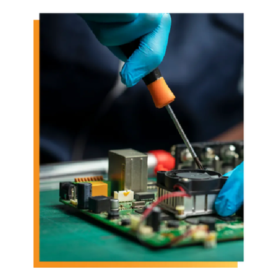 Gloved hand soldering a circuit board with a soldering iron, close-up