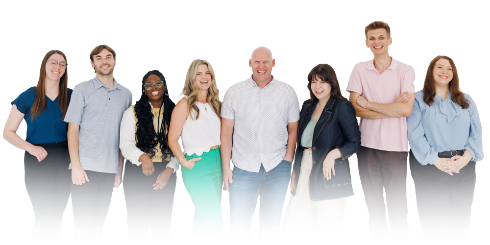 Seven people standing side by side, smiling on a white background, with a soft fade at the bottom