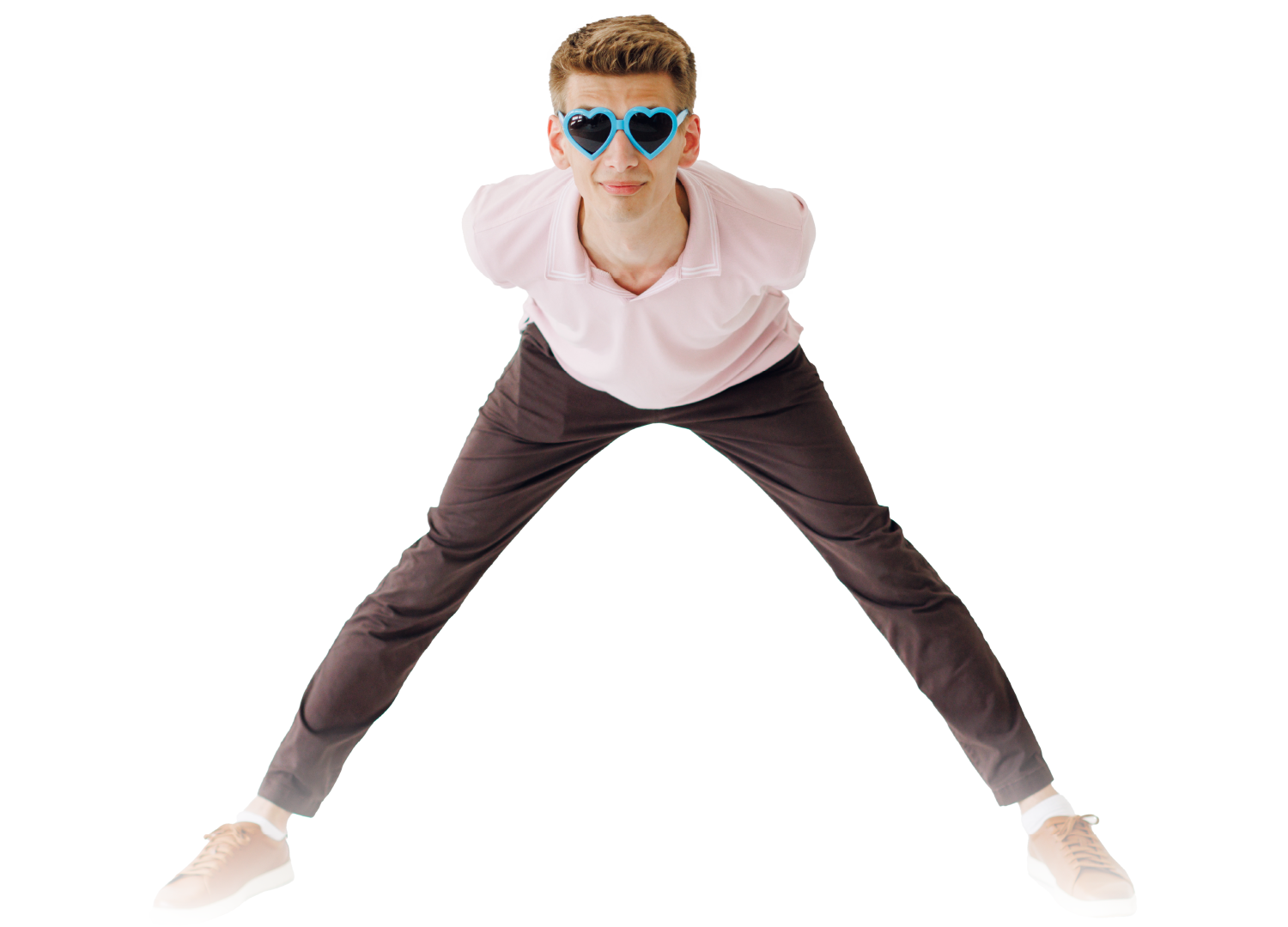 Person in sunglasses leans forward with legs wide apart against a white background.