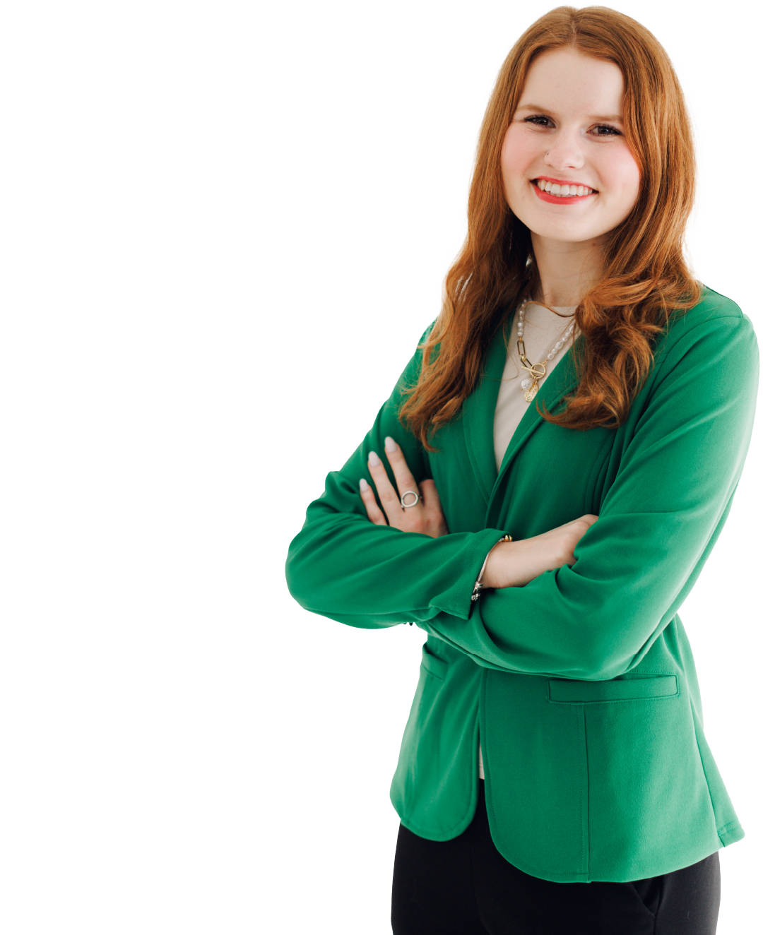 Smiling woman in a green blazer with arms crossed on a white background