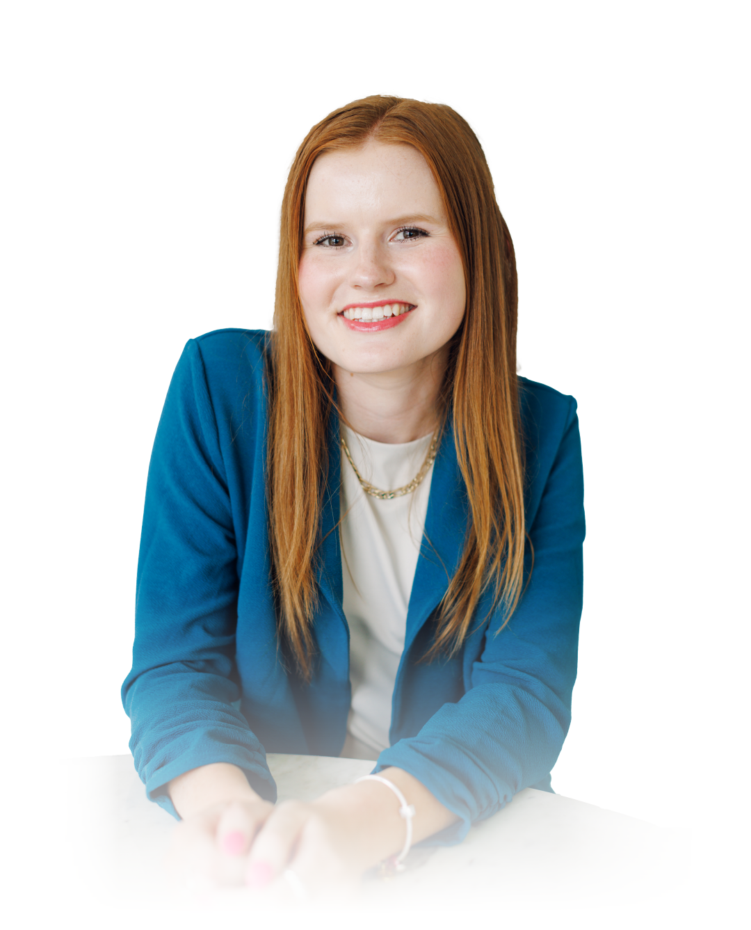 Smiling woman in a blue blazer leaning forward against a white background