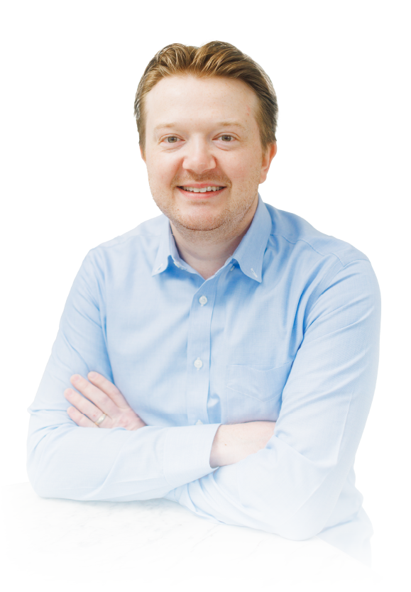 Smiling person in a light blue shirt with arms crossed against a white background