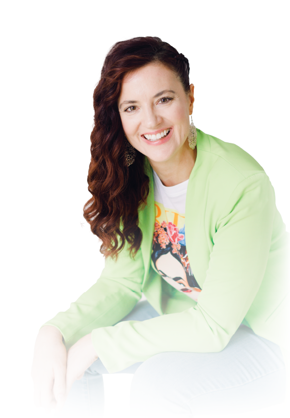 Smiling person seated on a white background, wearing a light green jacket and dark red hair.