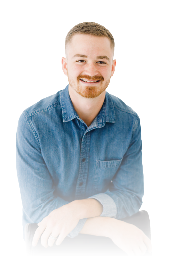 Smiling man in a blue denim shirt against a white background