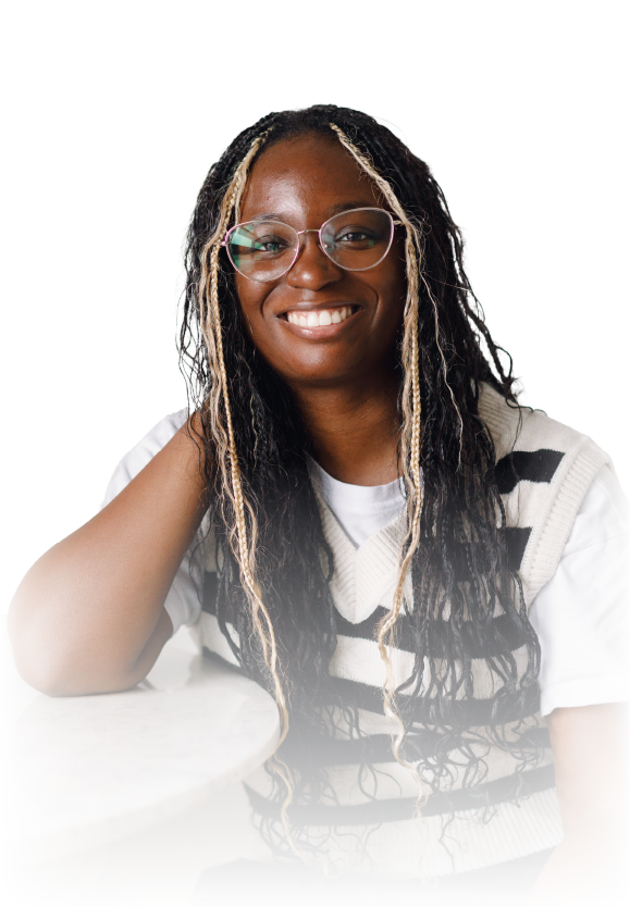 Smiling woman in glasses wearing a black blazer and white blouse against a white background