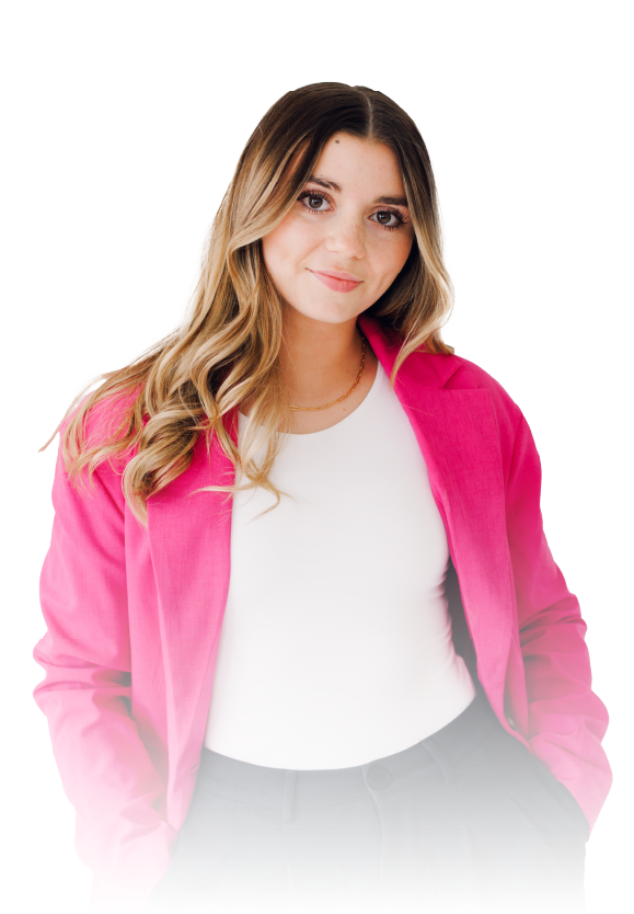 Woman in a bright pink jacket over a white top, standing against a white background with a slight smile